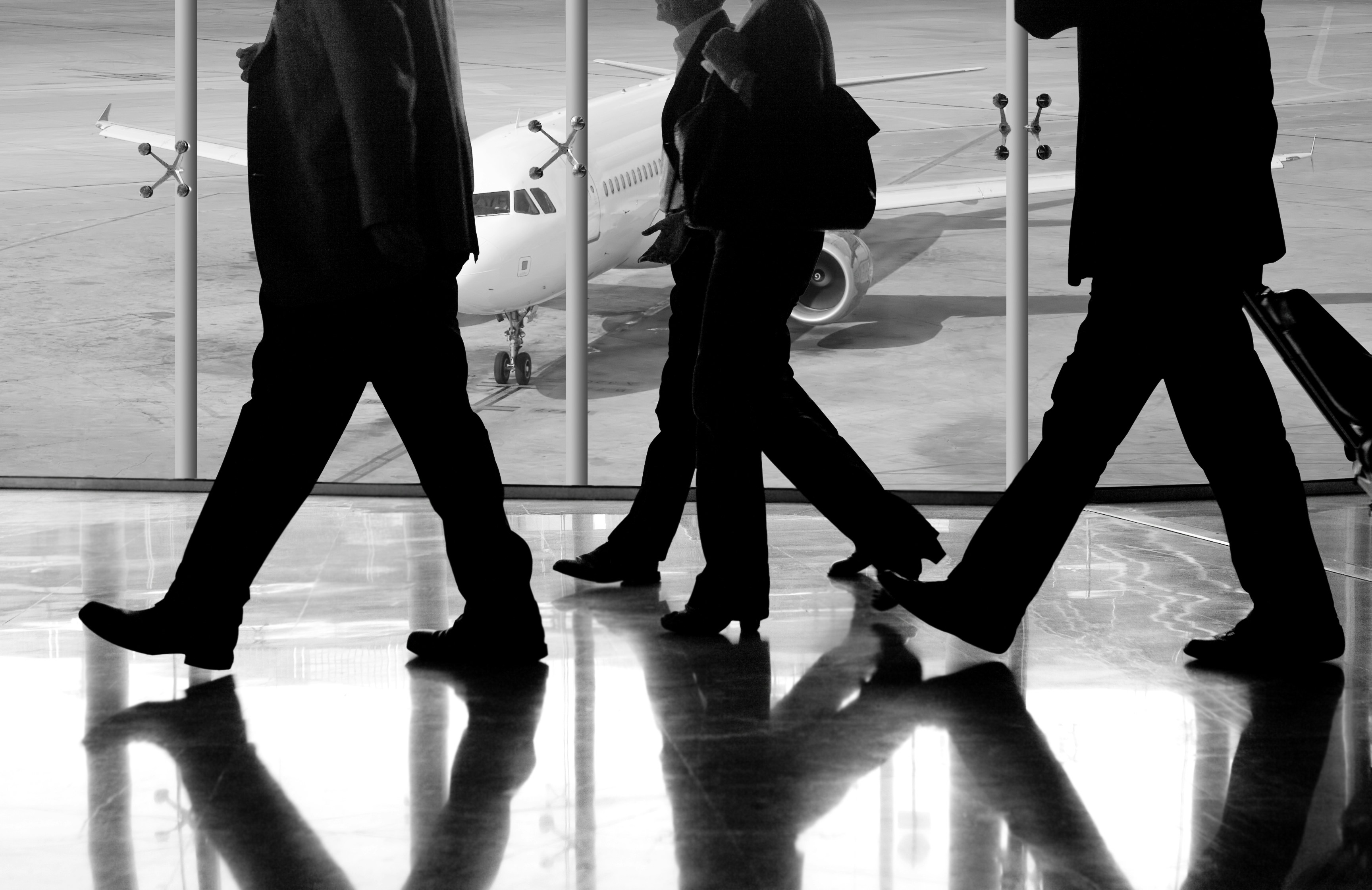 Silhouettes walking through an airport